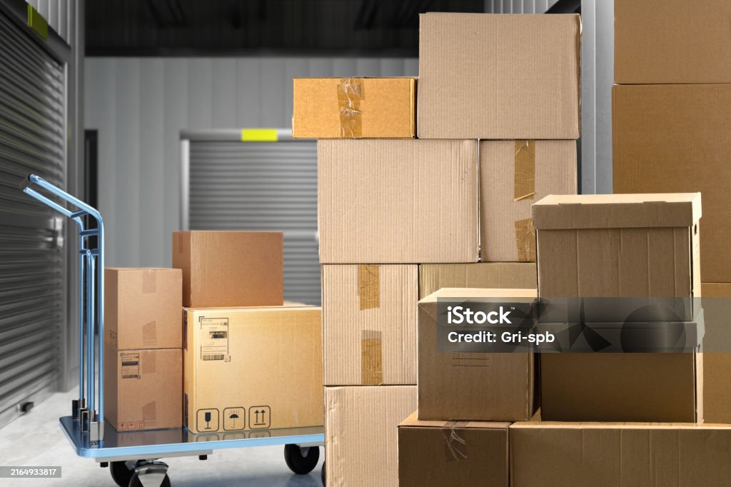 Warehouse with boxes. Storage space. Cardboard boxes in warehouse corridors. Building with separate storage units. Building with storage units without people. Cargo trolley with parcels. 3d image
